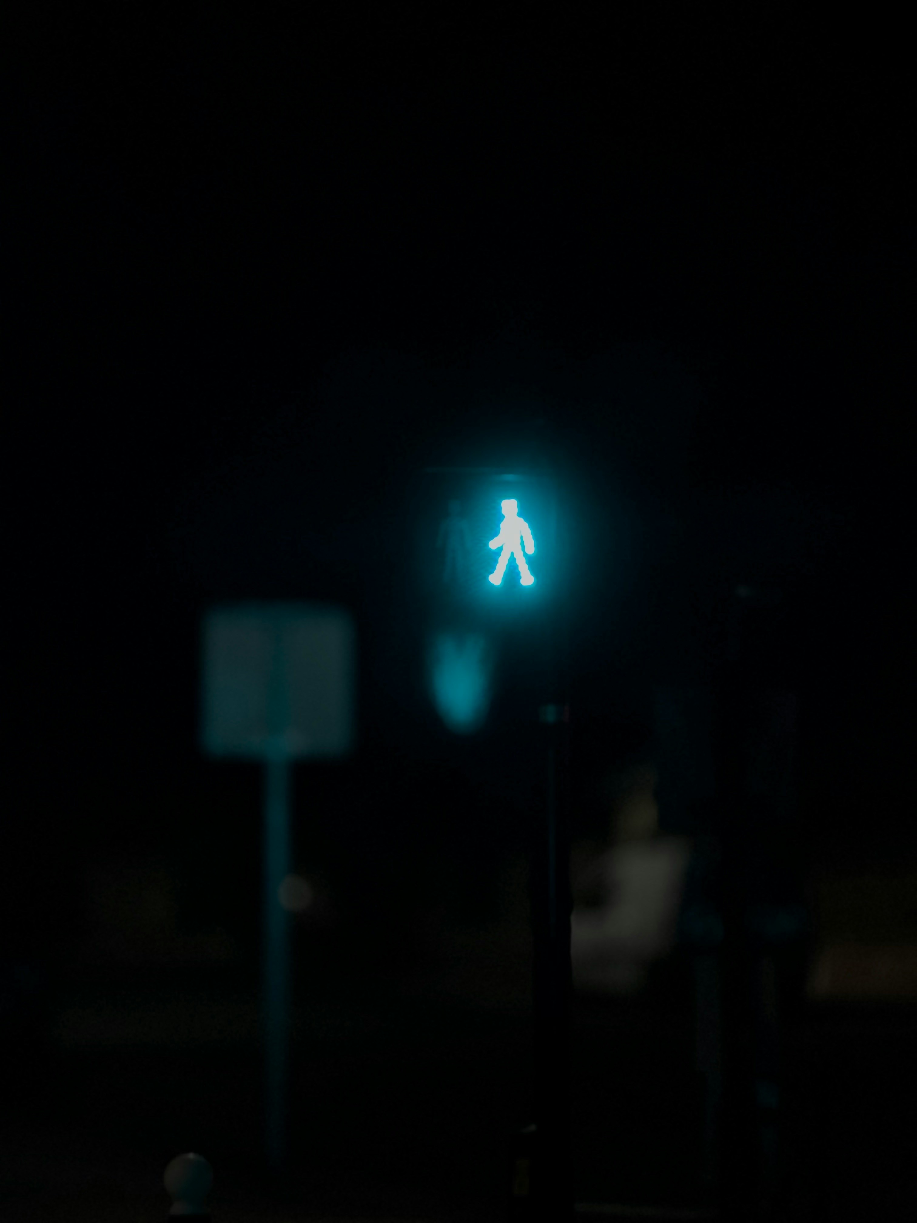 Photo of a pedestrian green light at night