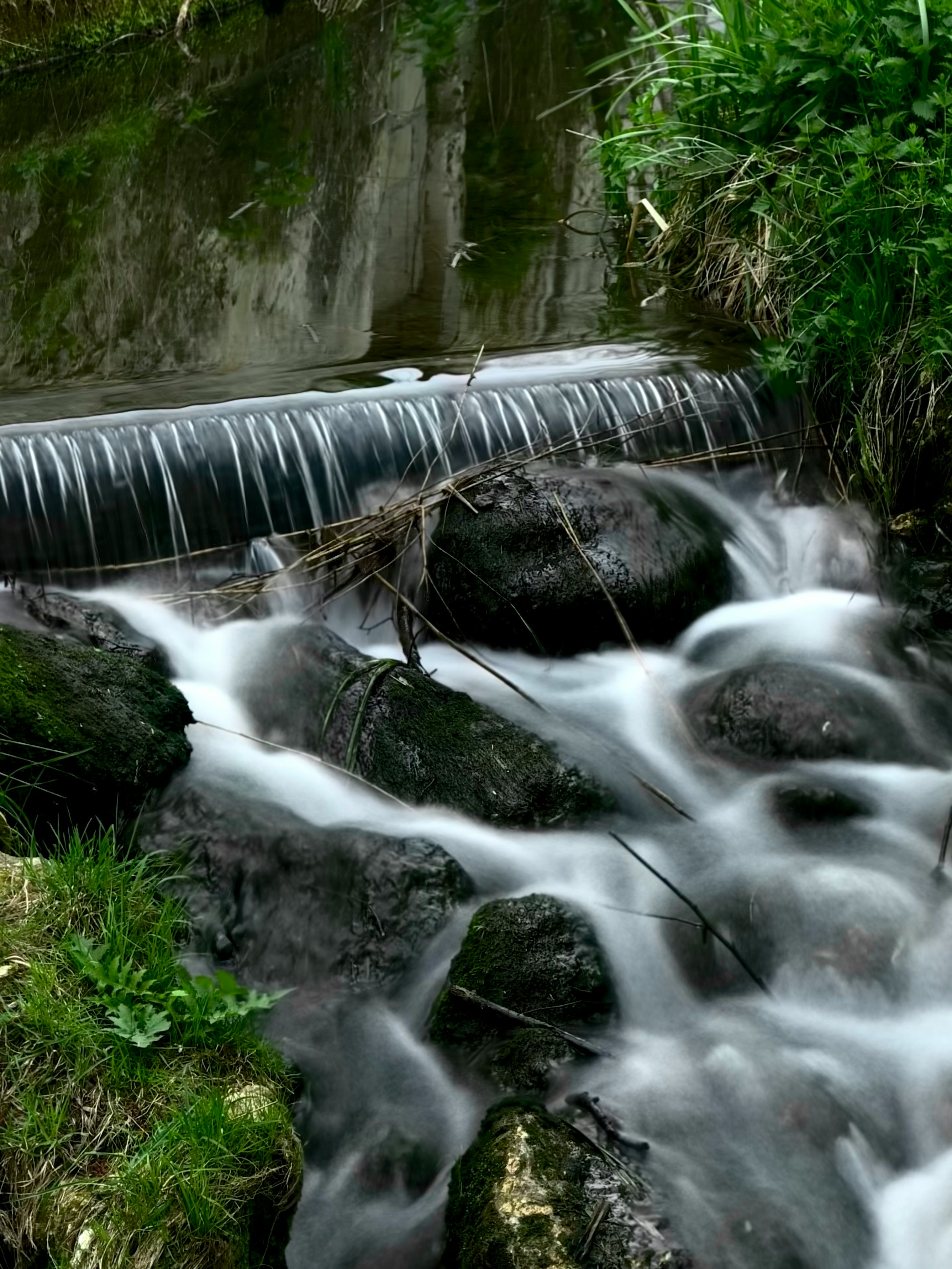 Long exposure photo of water flowing over some rocks